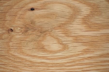 Close up view of the rays in the grain of a wide plank white oak floor.