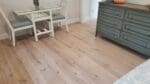 White oak live sawn character grade flooring, site finished with a matte white tone.