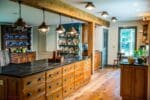 White painted solid bead board paneling on the walls and live sawn white oak wide plank flooring